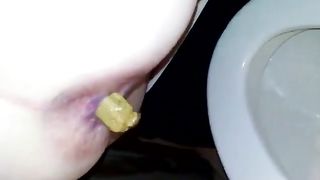 Yellow turd over toilet