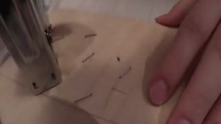 Using her homemade toilet