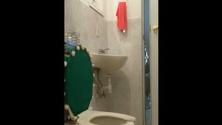 Brunette Asian mature shitting in toilet