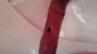 Shaved babe shitting in real close up