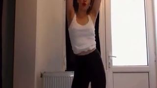 She's dancing and pooping in tight black pants
