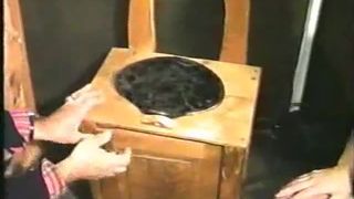 Shitting on wooden toilet