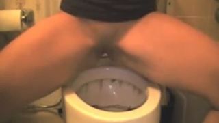 Beautiful blonde peeing over toilet