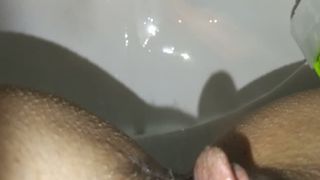 Fingering her pussy while pooping