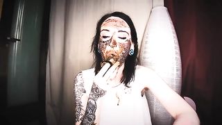 Beautiful brunette smears shit on her face