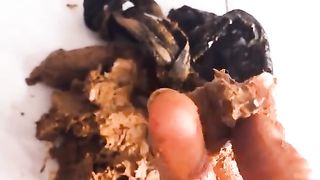 Beautiful girl smears shit on pussy