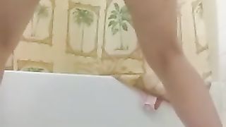 Shaking her ass while pooping