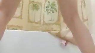 Shaking her ass while pooping
