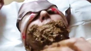Smearing shit on slave's face