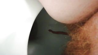 Close up of hairy milf shitting