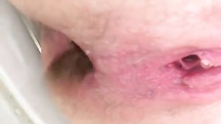 Shaved babe shits in close up