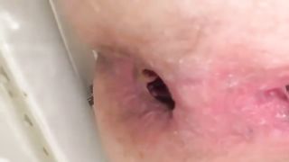 Shaved babe shits in close up