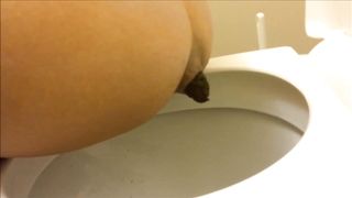 Nice brunette shits over toilet