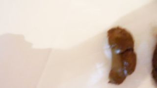 Hairy babe shits in the bathtub