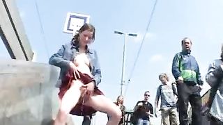 crazy girl pisses in public with people passing by