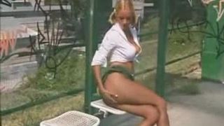 blond pisses outside at a bus stop
