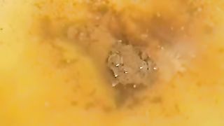 pooping girl takes a very smelly poop in the bath