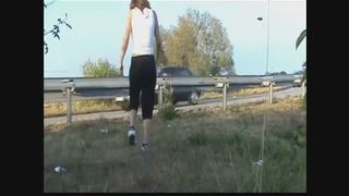 Woman pooping near the road