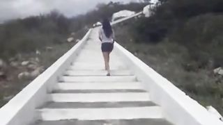 Sexy babe peeing on the rocks