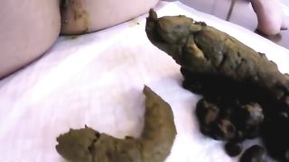 Masked brunette shitting on white napkin