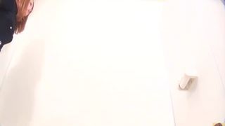 Brown haired japanese using a public bathroom