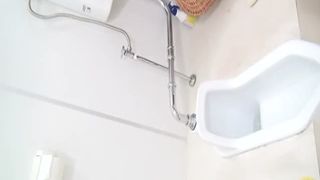 Brown haired babe shitting in public bathroom