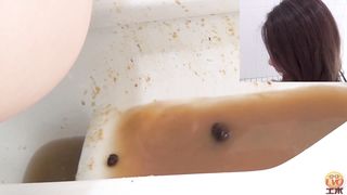 Dark haired beauty shitting