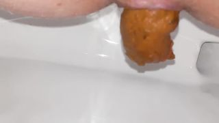 Close up of shaved babe shitting