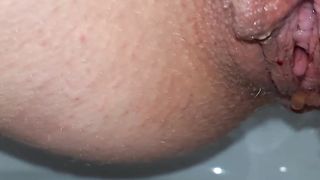 Close up of shaved babe shitting