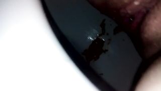 Shaved babe shitting