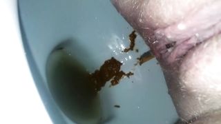 Shaved babe shitting