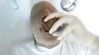 Feeding chubby slave with shit
