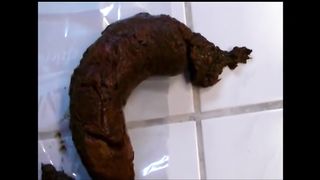 Woman shitting a long hard turd