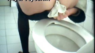 Mature woman poops liquid in a public toilet