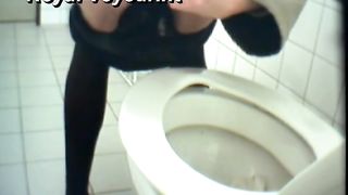 Mature woman poops liquid in a public toilet