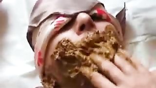 Brown shit from slave's face