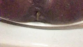 Ebony girl pooping in close up