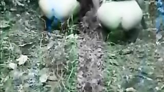 Two hot girls poop in a forest