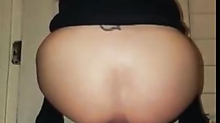 Tattooed girl shits on white plate