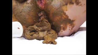 Mature lady masturbating with brush and shitting