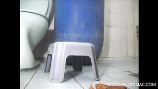 She's shitting on bathroom floor