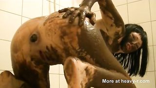 Dark haired beauty smears poop