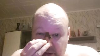 Bald dude rubbing shit all over his face