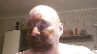 Bald dude rubbing shit all over his face