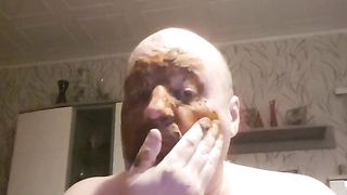 Bald dude rubbing shit all over his face
