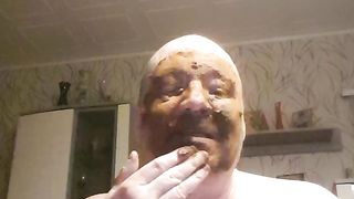 Bald dude rubbing shit all over his face