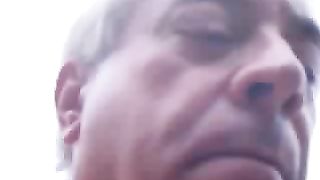 Mature dude playing with his poop outdoor