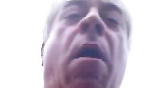 Mature dude playing with his poop outdoor