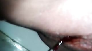 Closeup of lady in her periods pooping