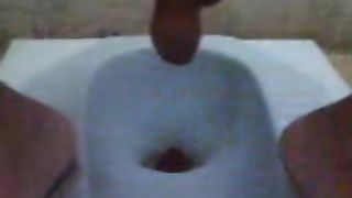 Guy pooping in the toilet